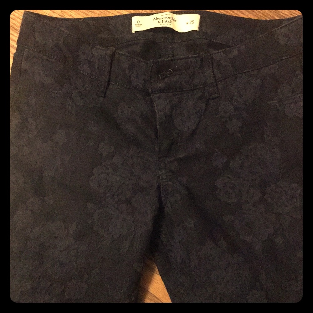 Dark blue skinny jeans with same color flowers